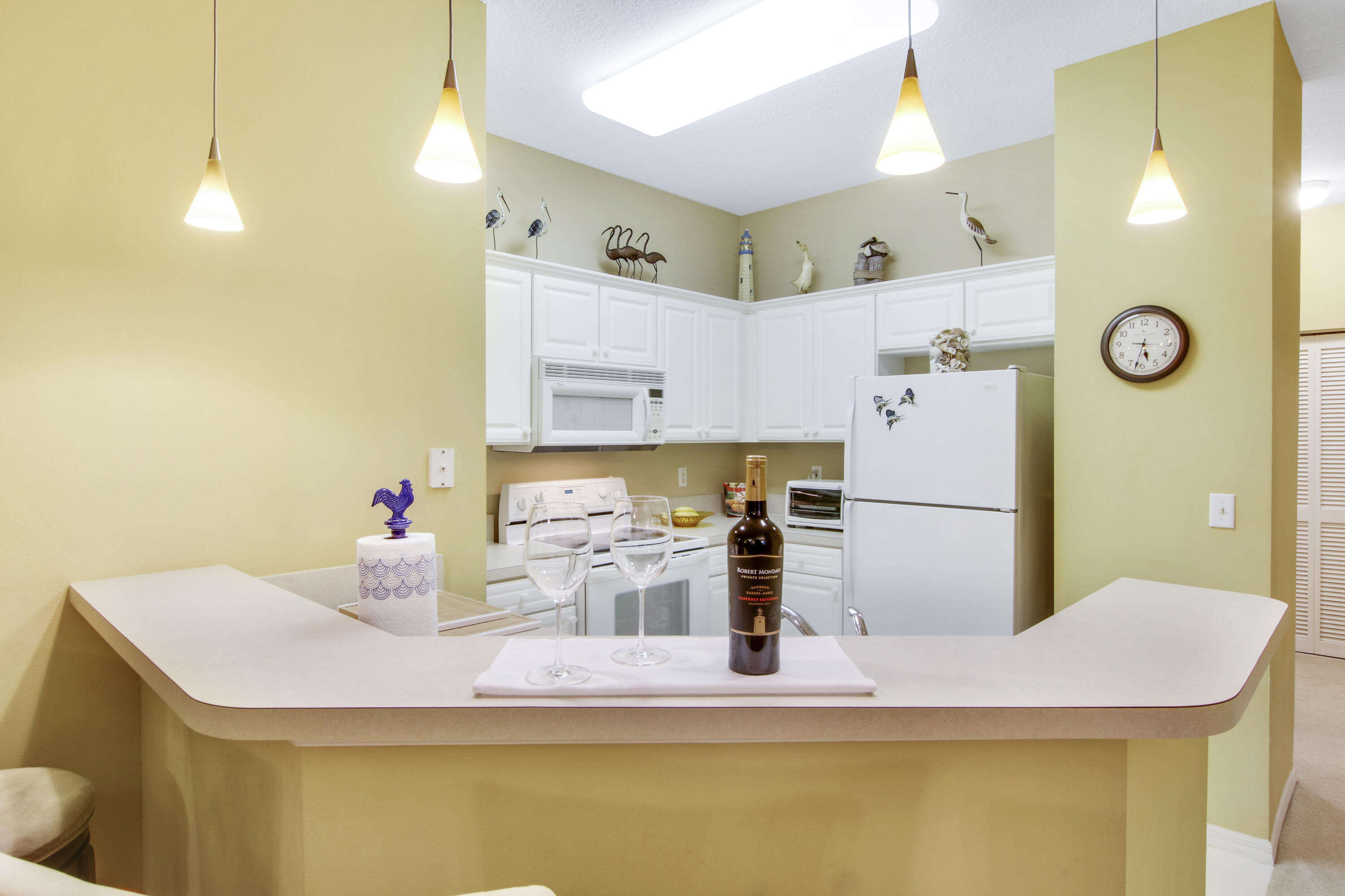 108 Lighthouse Circle, Unit B Jupiter, FL 33469 - Photo 16 of 33 a kitchen with a refrigerator and a sink