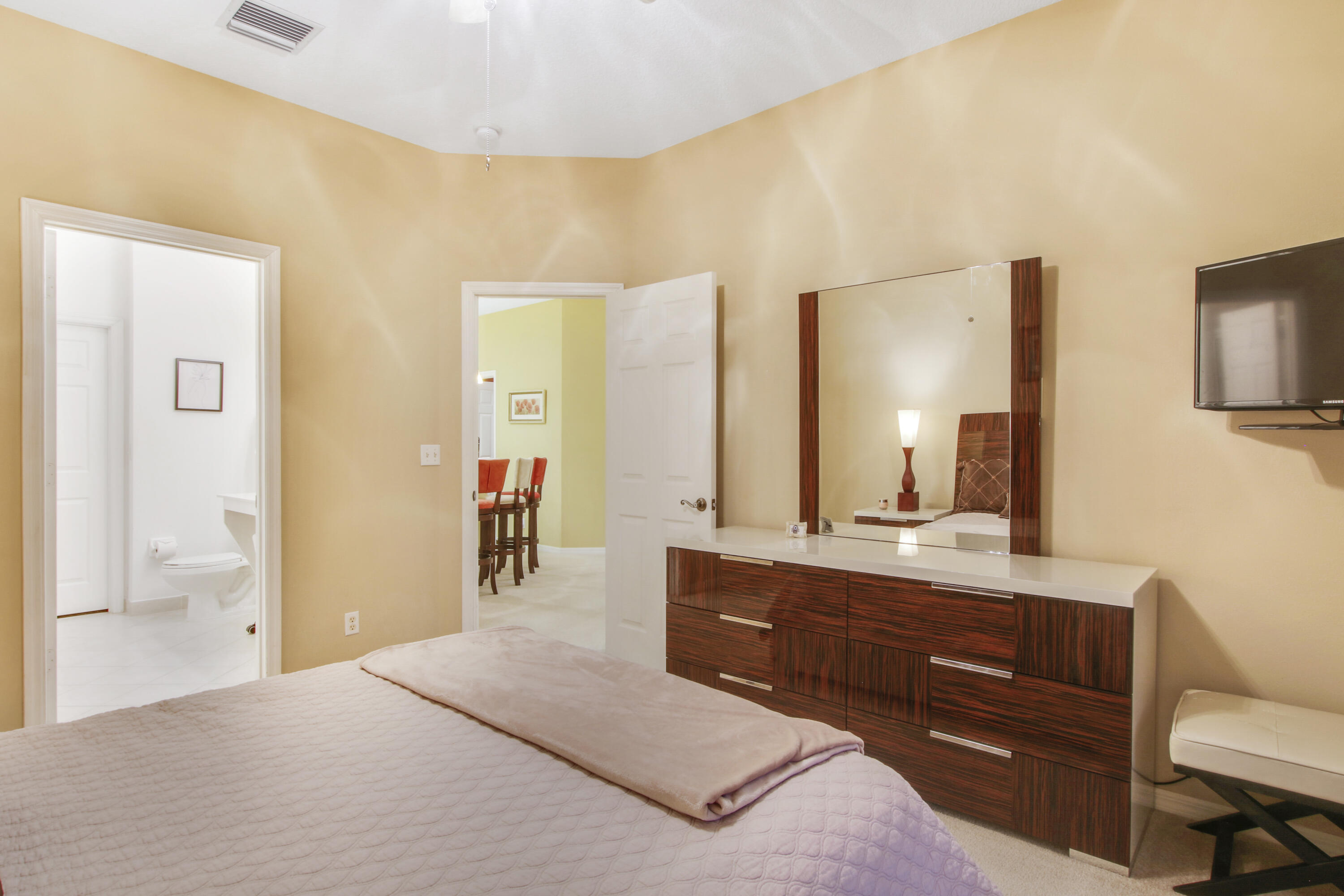 108 Lighthouse Circle, Unit B Jupiter, FL 33469 - Photo 18 of 33 a en suite bathroom with a granite countertop sink and a mirror