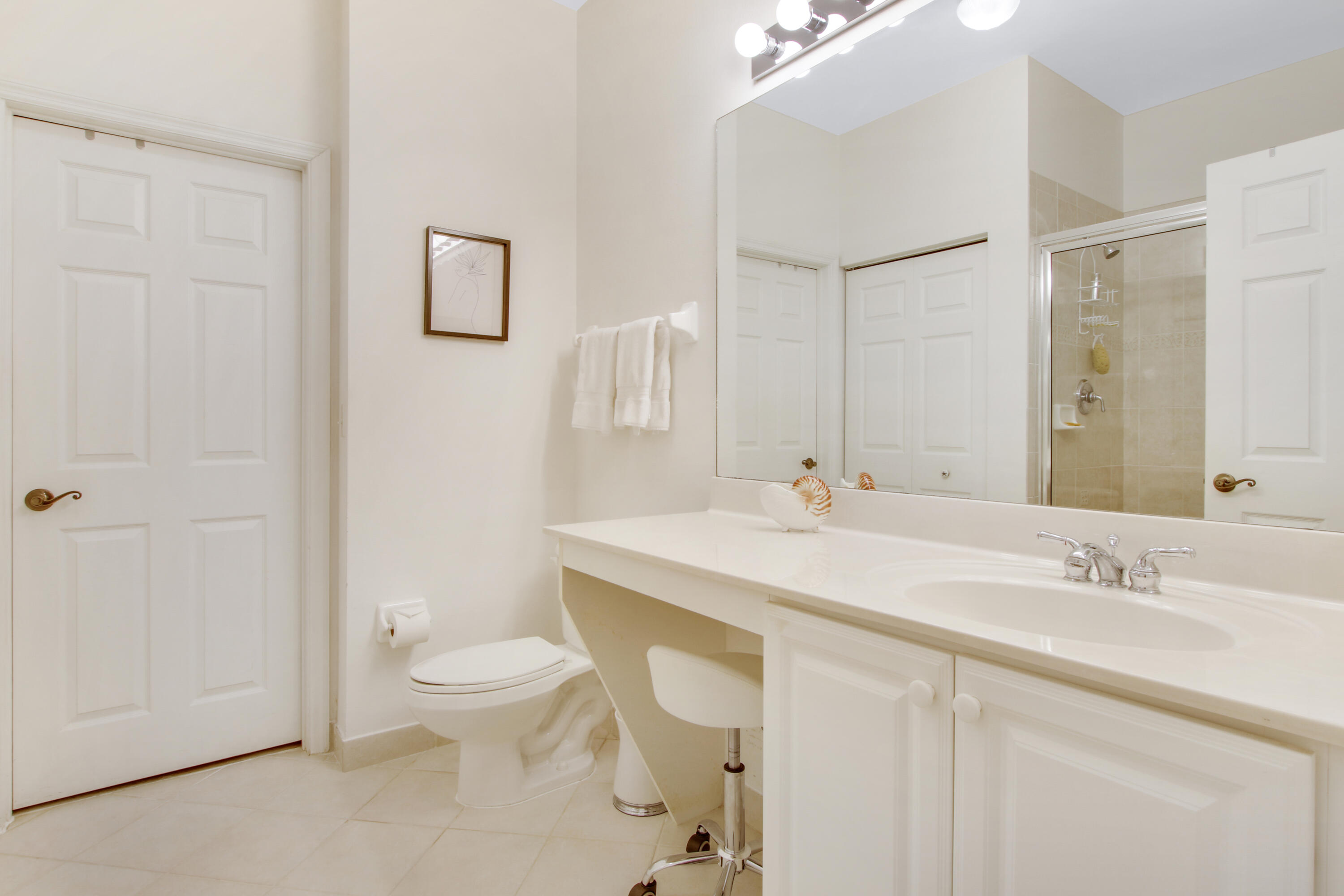 108 Lighthouse Circle, Unit B Jupiter, FL 33469 - Photo 20 of 33 a bathroom with a toilet a sink a mirror and a shower