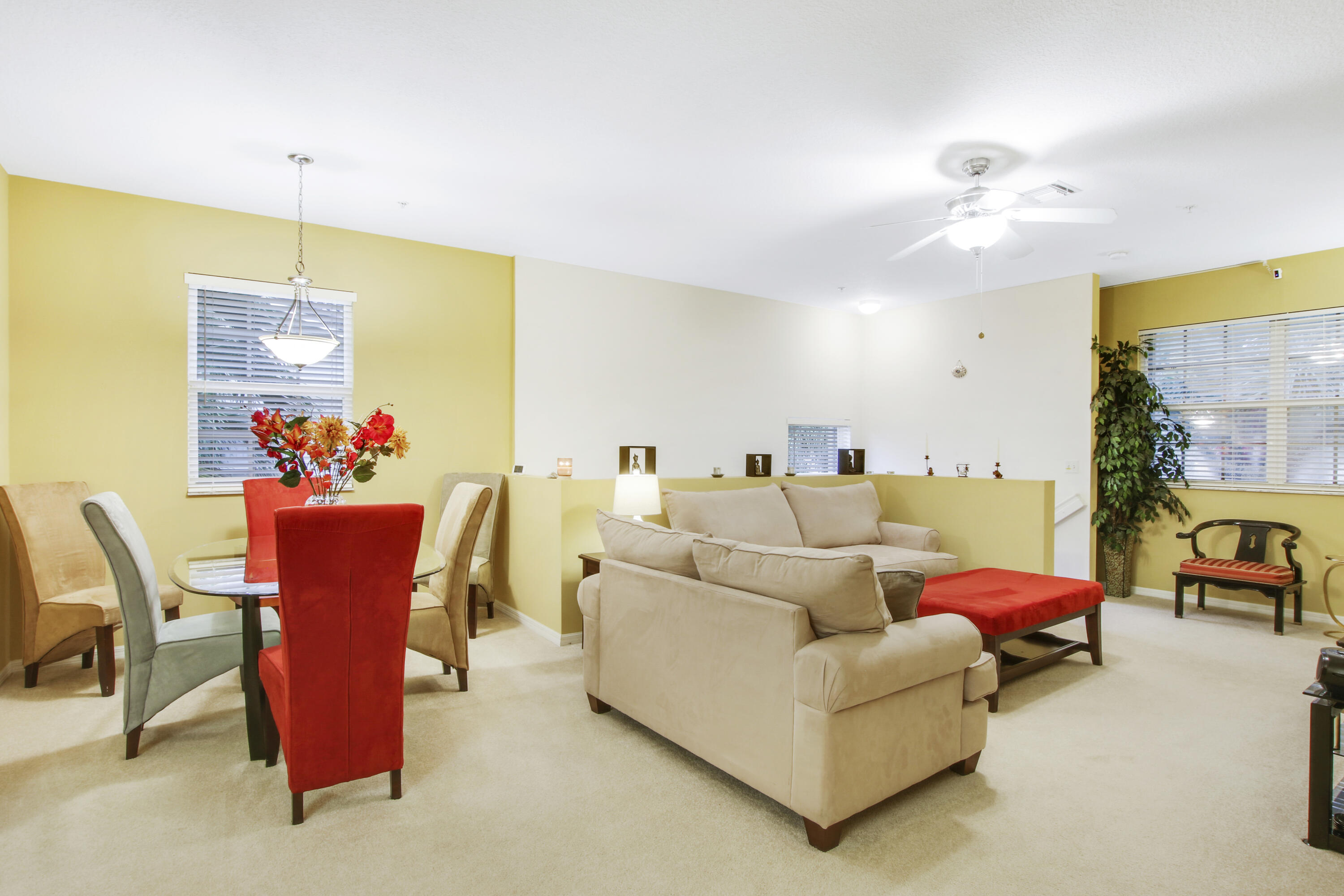 108 Lighthouse Circle, Unit B Jupiter, FL 33469 - Photo 9 of 33 a living room with furniture kitchen view and a chandelier