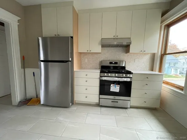 a kitchen with cabinets and window