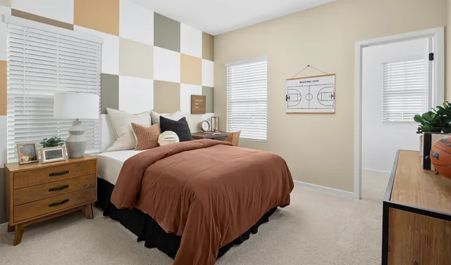 a bedroom with a bed and a potted plant