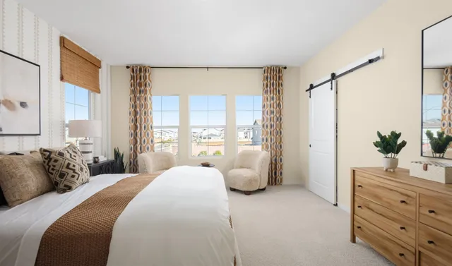 a spacious bedroom with a large bed and a window