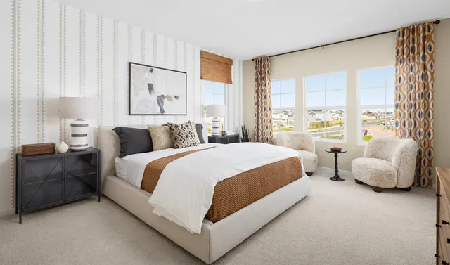 a spacious bedroom with a bed and a couch