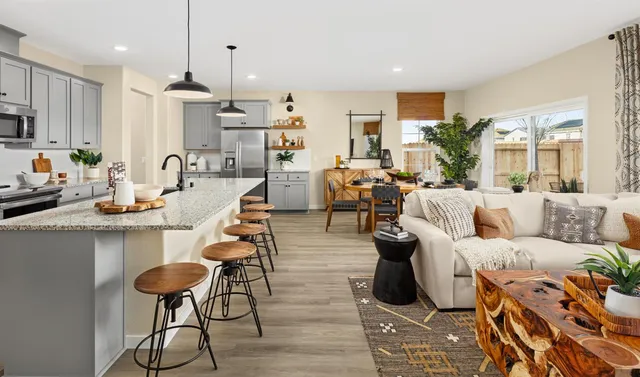 a living room with lots of furniture and kitchen view