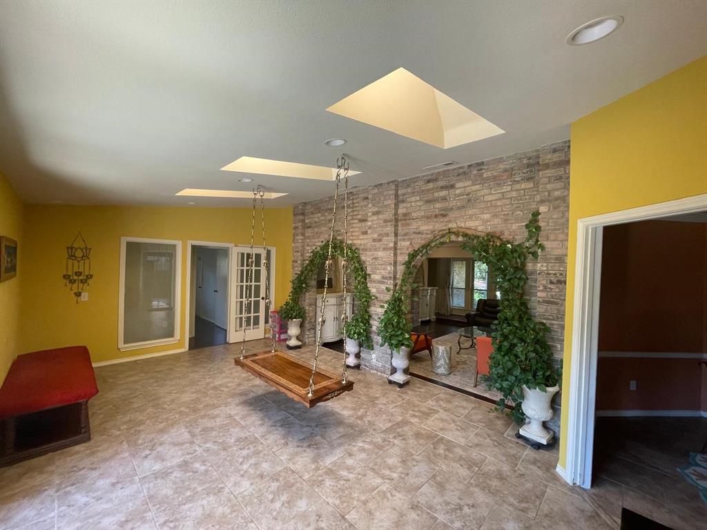 3612 Cross Bend Road Plano, TX 75023 - Photo 11 of 38 Unfurnished living room with tile flooring and a skylight