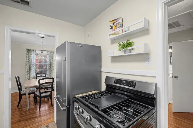 a kitchen with stainless steel appliances granite countertop a stove and a refrigerator
