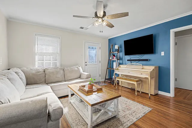 a living room with furniture and a flat screen tv