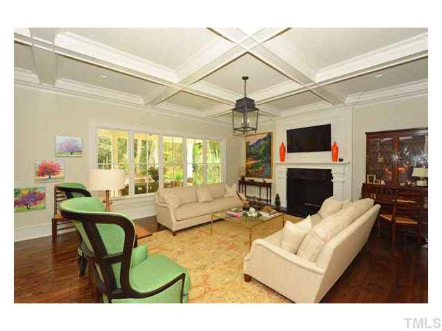 418 Forsyth Street Raleigh, NC 27609 - Photo 7 of 25 a living room with furniture a fireplace and a flat screen tv