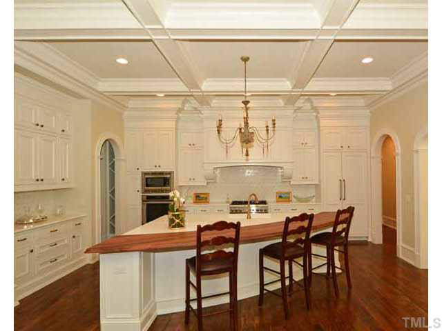 418 Forsyth Street Raleigh, NC 27609 - Photo 8 of 25 a kitchen with a table chairs and a refrigerator