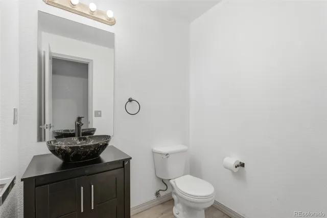 a bathroom with a toilet a sink and mirror