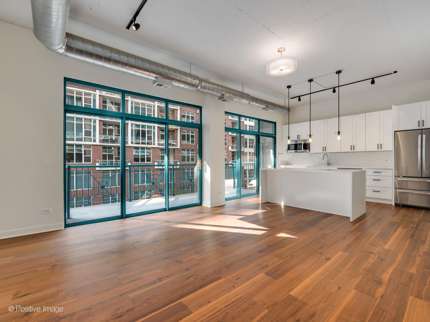 910 West Madison Street, Unit 403 Chicago, IL 60607 - Photo 3 of 12 a view of an empty room with kitchen and a window
