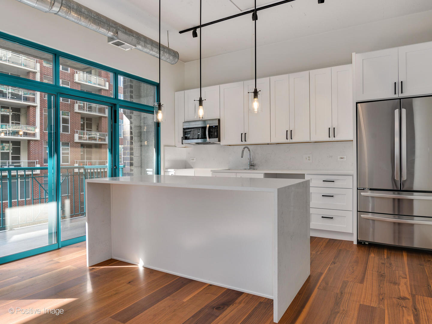 910 West Madison Street, Unit 403 Chicago, IL 60607 - Photo 4 of 12 a kitchen with stainless steel appliances a refrigerator and wooden floor