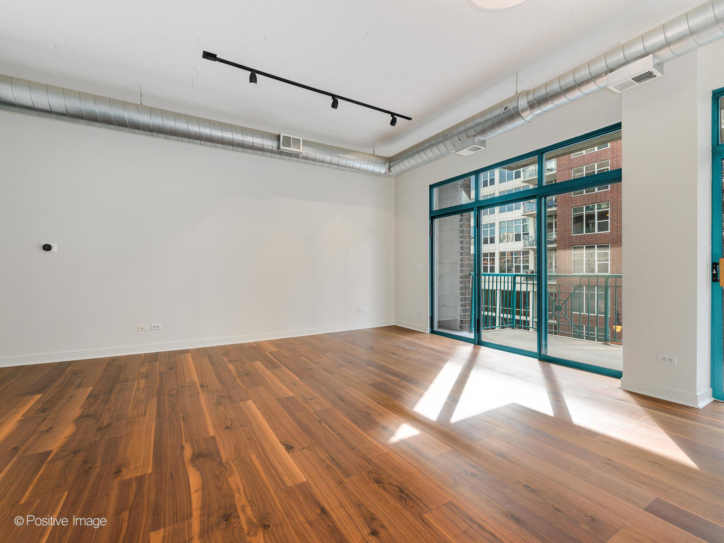 910 West Madison Street, Unit 403 Chicago, IL 60607 - Photo 7 of 12 a view of an empty room with wooden floor and a window