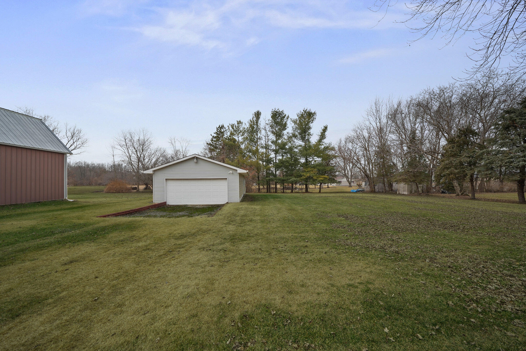 756 South 375 West Hebron, IN 46341 - Photo 17 of 21 a backyard of a house with plants and large trees