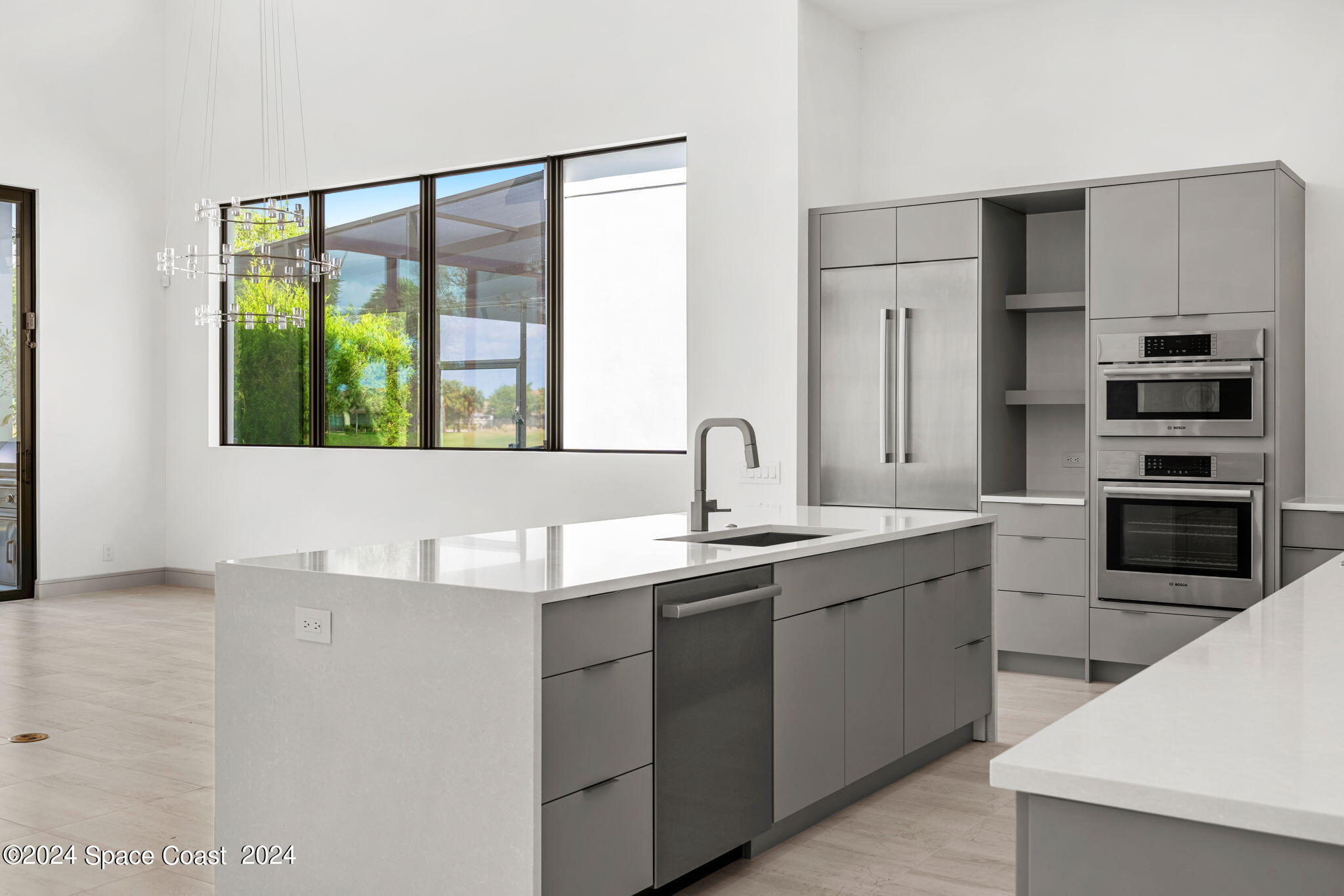 6374 Modern Duran Drive Melbourne, FL 32940 - Photo 13 of 55 a kitchen with stainless steel appliances a sink stove and cabinets