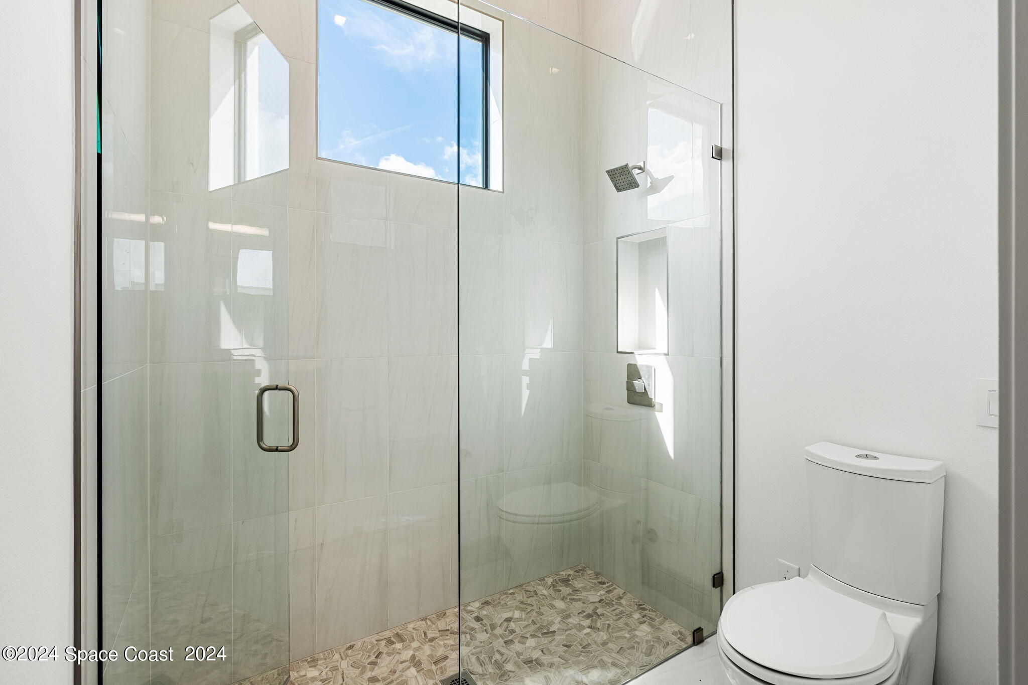 6374 Modern Duran Drive Melbourne, FL 32940 - Photo 27 of 55 a bathroom with a toilet and a shower