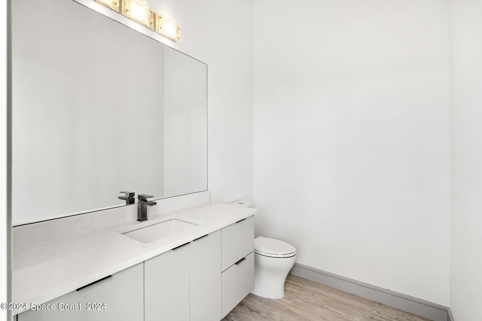6374 Modern Duran Drive Melbourne, FL 32940 - Photo 29 of 55 a bathroom with a sink and a toilet