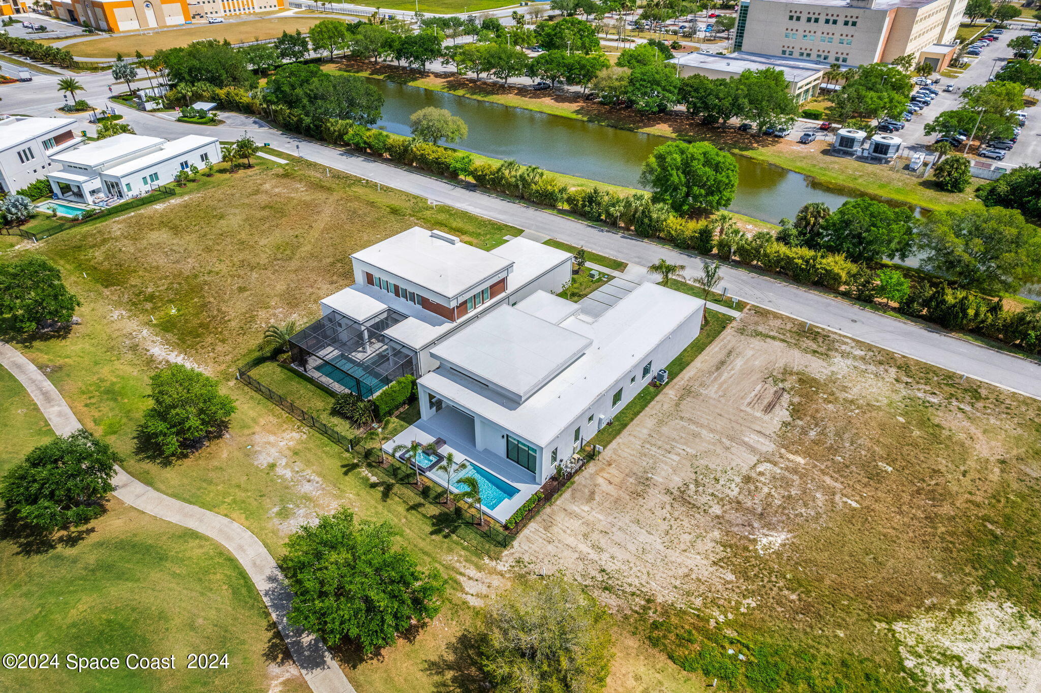 6374 Modern Duran Drive Melbourne, FL 32940 - Photo 43 of 55 an aerial view of a house with a lake view