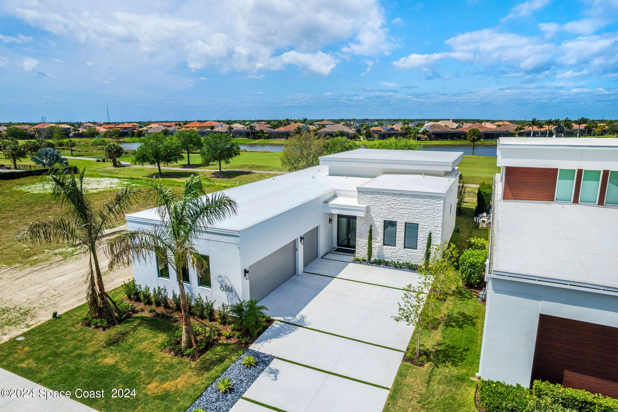 6374 Modern Duran Drive Melbourne, FL 32940 - Photo 44 of 55 an aerial view of a house with a garden
