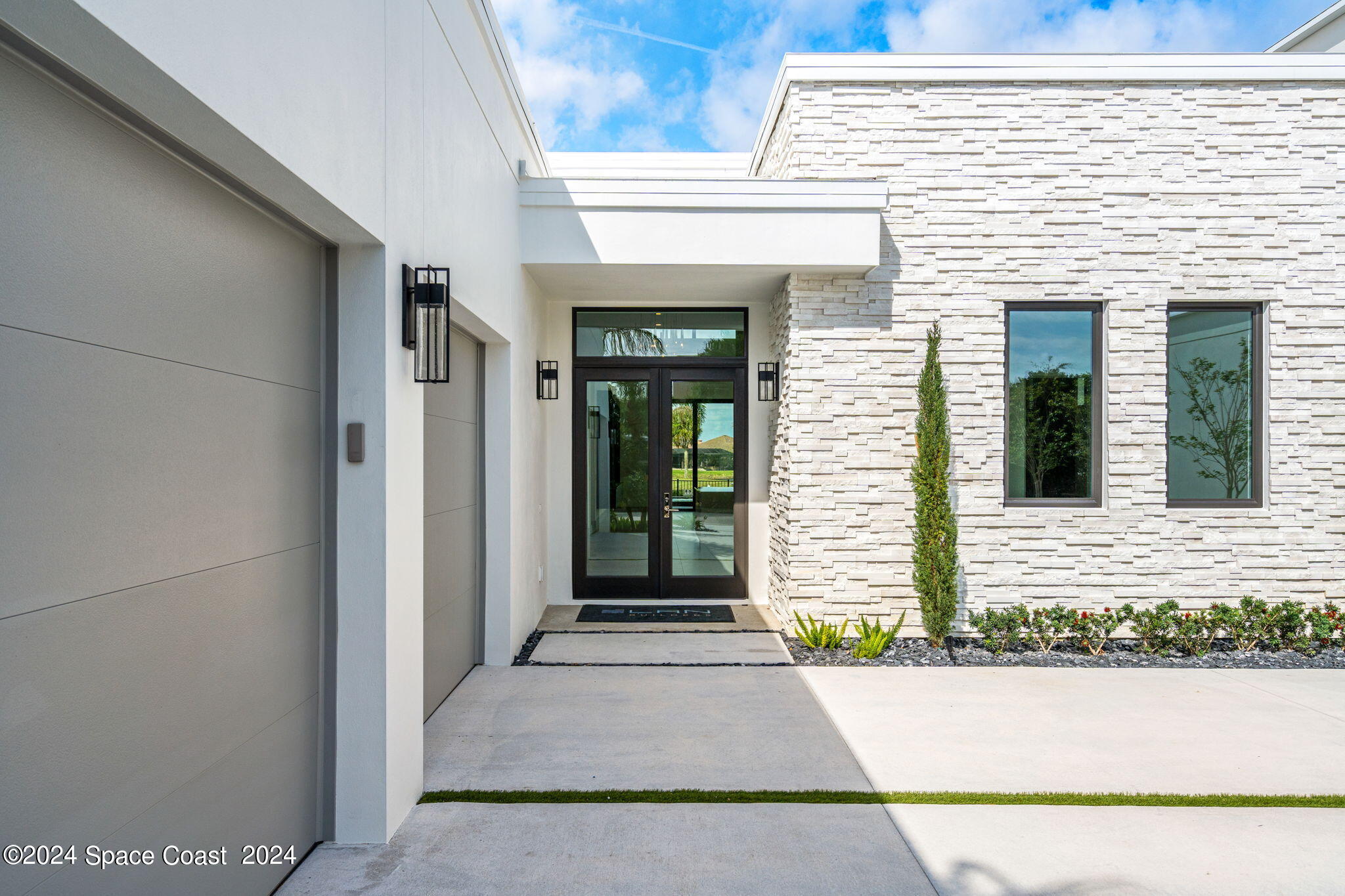 6374 Modern Duran Drive Melbourne, FL 32940 - Photo 50 of 55 a view of a entryway door front of a house