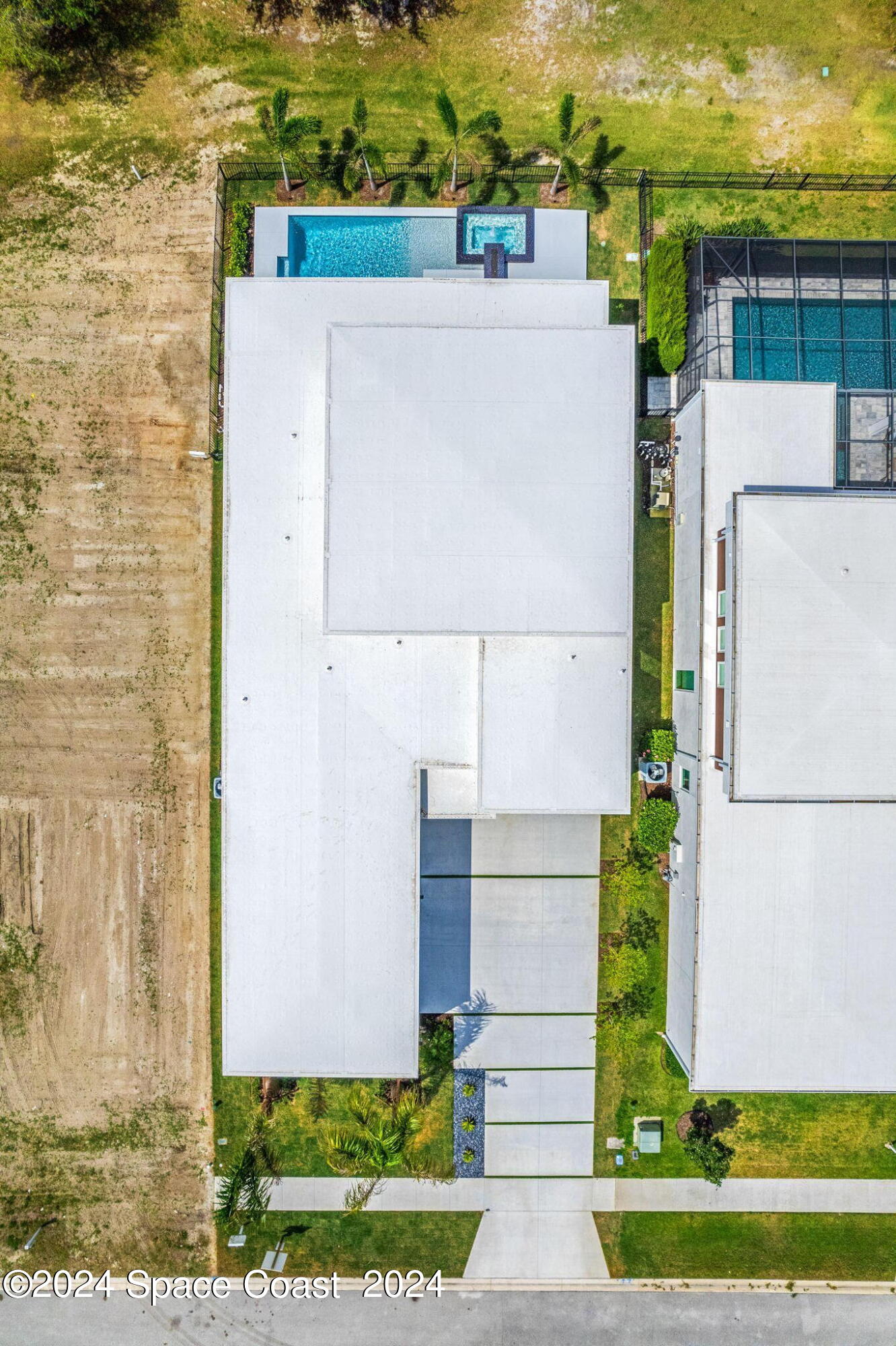 6374 Modern Duran Drive Melbourne, FL 32940 - Photo 53 of 55 a aerial view of a house with a yard and plants