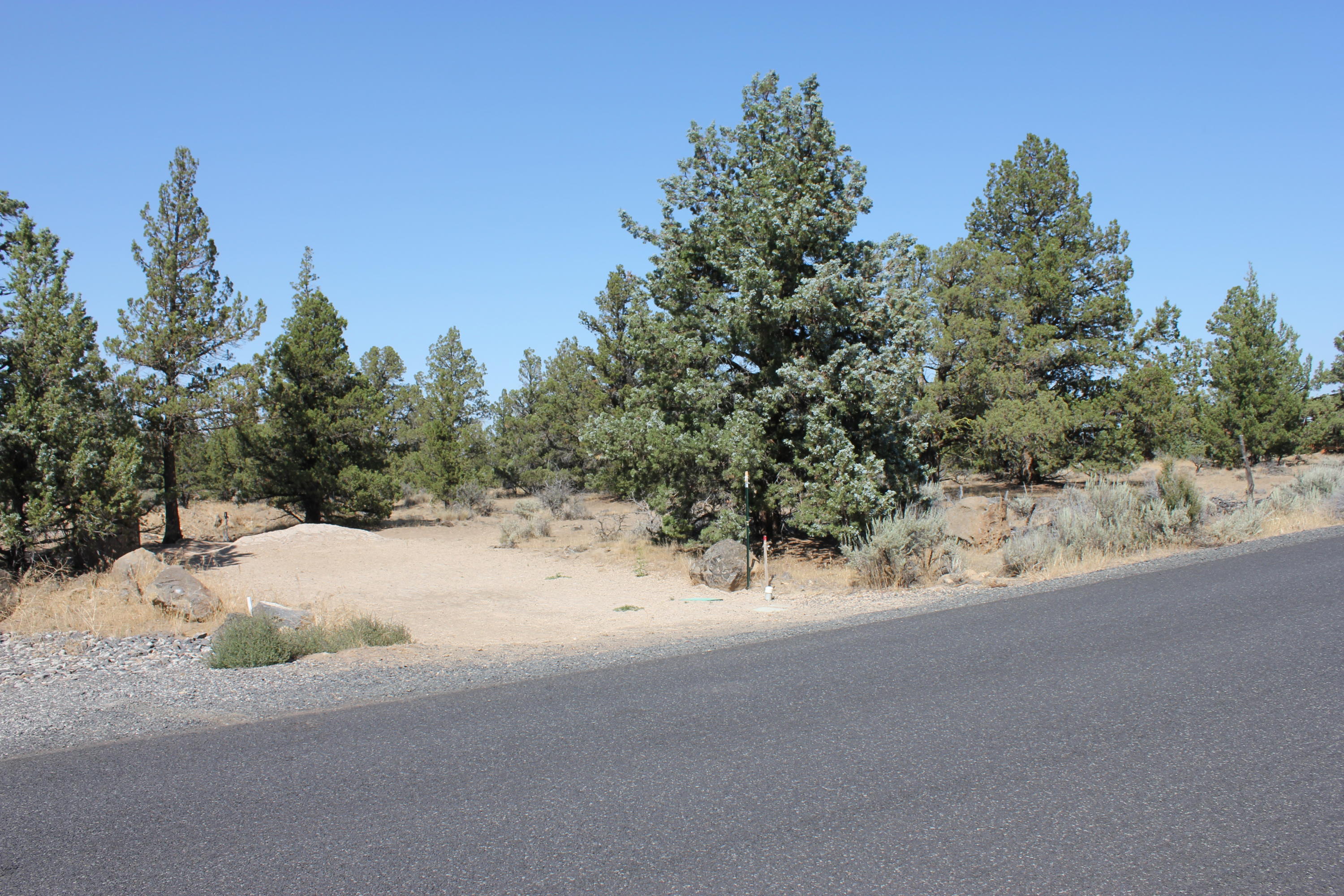 20914 Southwest Gift Road Bend, OR 97703 - Photo 16 of 19 a view of a road with a trees in the background