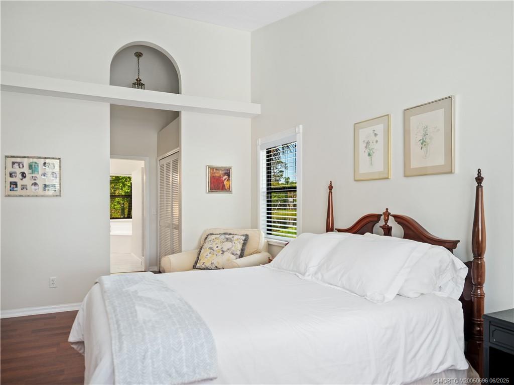 5692 Southeast Lamay Drive Stuart, FL 34997 - Photo 15 of 28 a bedroom with a bed and a window