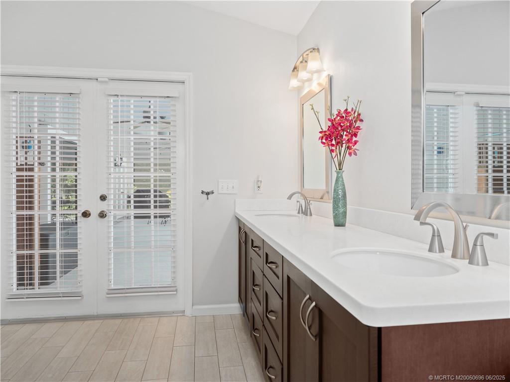 5692 Southeast Lamay Drive Stuart, FL 34997 - Photo 18 of 28 a bathroom with a sink vanity and a mirror