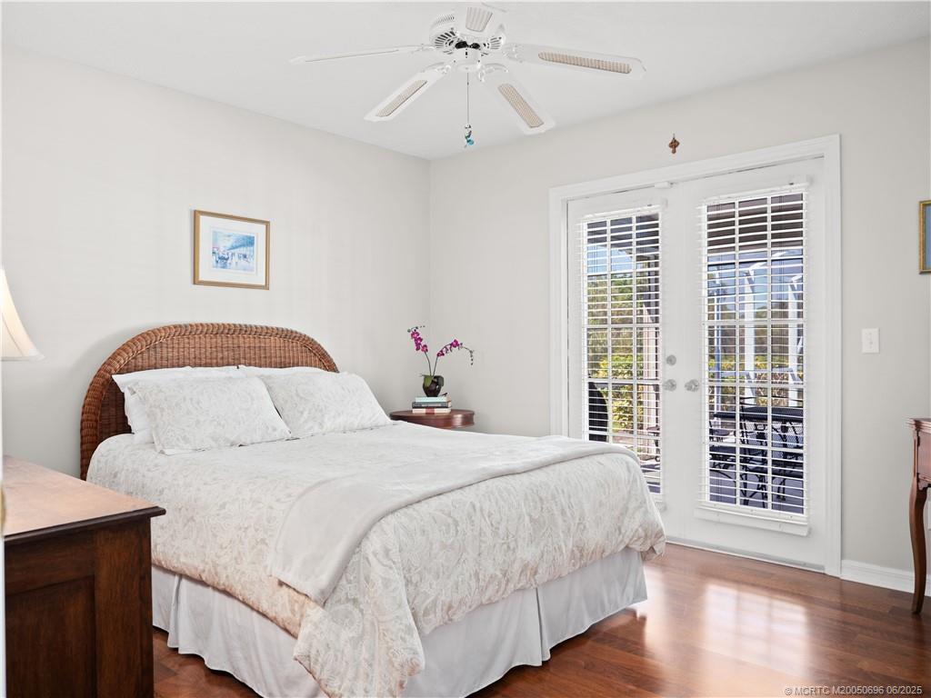5692 Southeast Lamay Drive Stuart, FL 34997 - Photo 19 of 28 a bedroom with a large bed and a window
