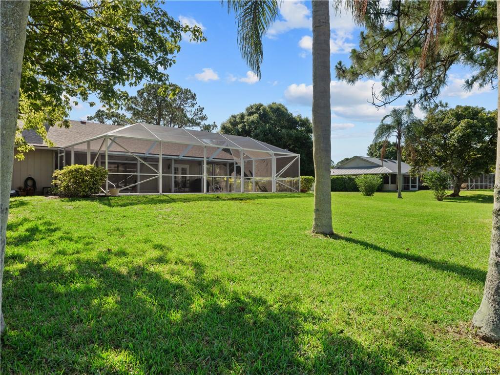 5692 Southeast Lamay Drive Stuart, FL 34997 - Photo 24 of 28 a view of a house with a yard and sitting area