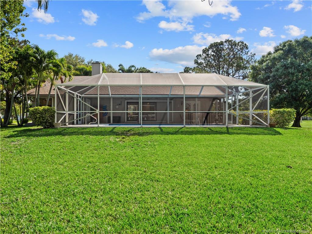 5692 Southeast Lamay Drive Stuart, FL 34997 - Photo 25 of 28 a view of a house with a yard and sitting area