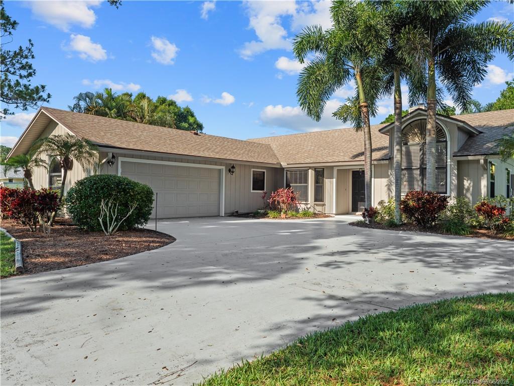 5692 Southeast Lamay Drive Stuart, FL 34997 - Photo 3 of 28 front view of a house with a yard