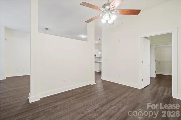 a view of an empty room with wooden floor