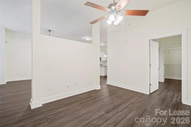 a view of an empty room with wooden floor
