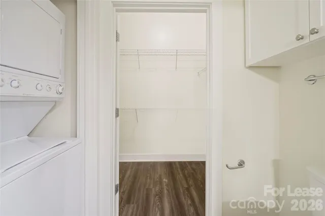 a view of walk in closet with empty racks