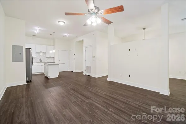 a view of a kitchen with a sink and a refrigerator