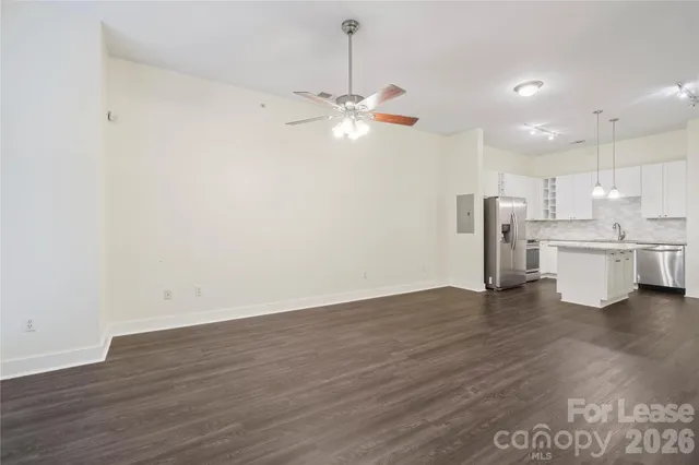 a view of kitchen with refrigerator and microwave