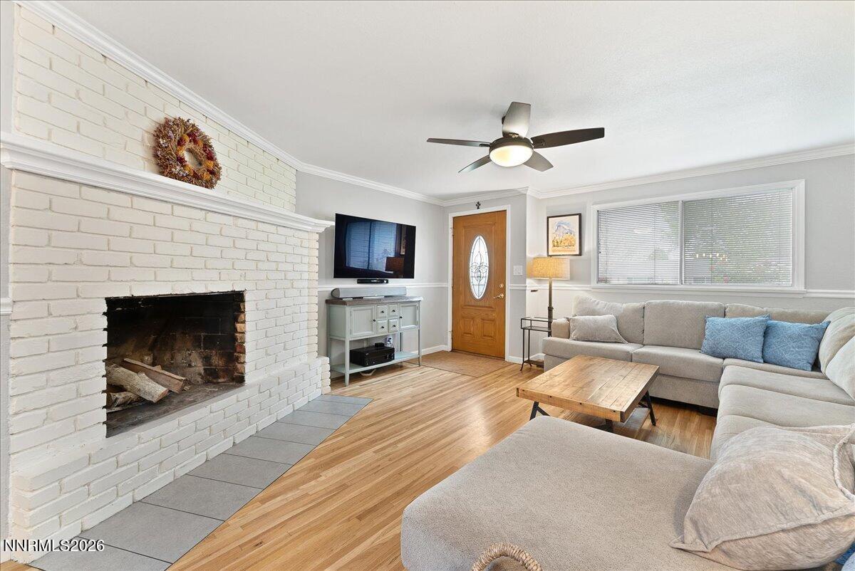 2205 Carlin Street Reno, NV 89503 - Photo 7 of 51 a living room with furniture a fireplace and a flat screen tv
