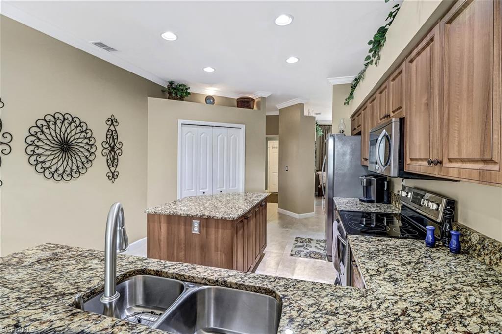 21156 Braxfield Loop Estero, FL 33928 - Photo 13 of 43 a kitchen with granite countertop a sink and a stove top oven