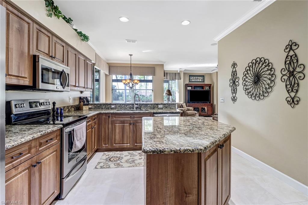 21156 Braxfield Loop Estero, FL 33928 - Photo 14 of 43 a kitchen with stainless steel appliances granite countertop a kitchen island a stove and a sink