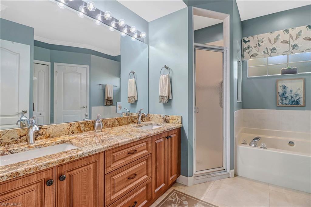 21156 Braxfield Loop Estero, FL 33928 - Photo 17 of 43 a bathroom with a granite countertop double vanity sink mirror and shower