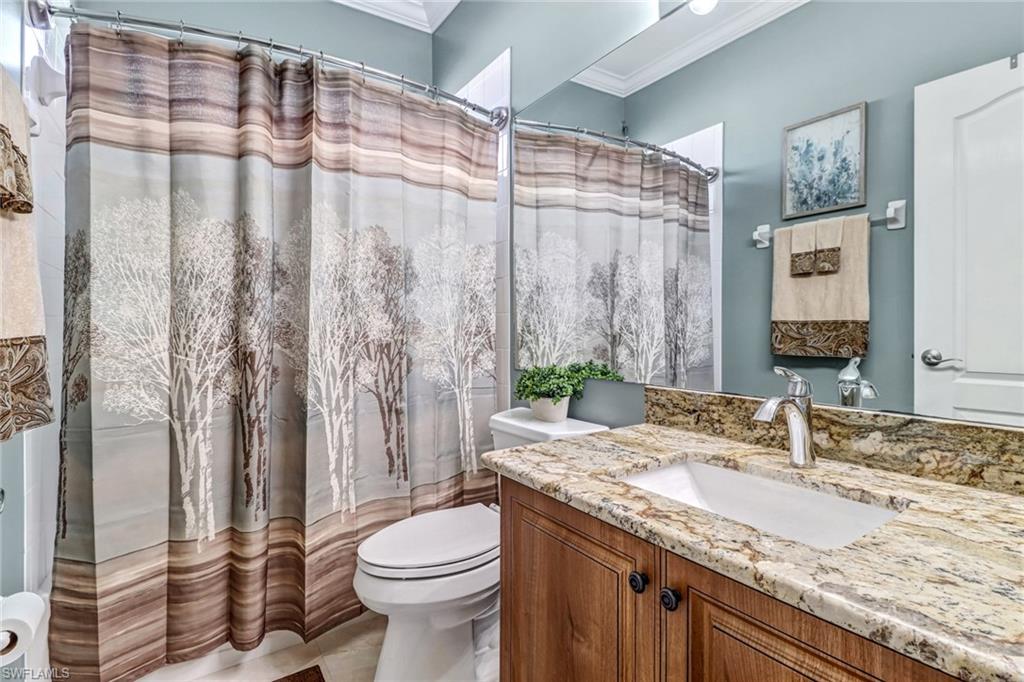 21156 Braxfield Loop Estero, FL 33928 - Photo 20 of 43 a bathroom with a granite countertop sink toilet and shower