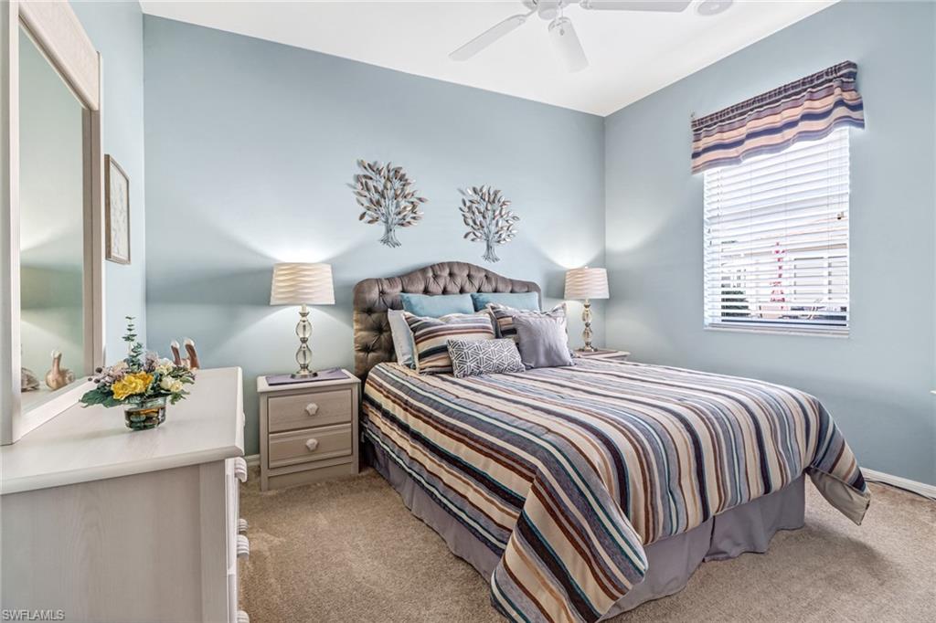 21156 Braxfield Loop Estero, FL 33928 - Photo 21 of 43 a bedroom with a bed and a chandelier