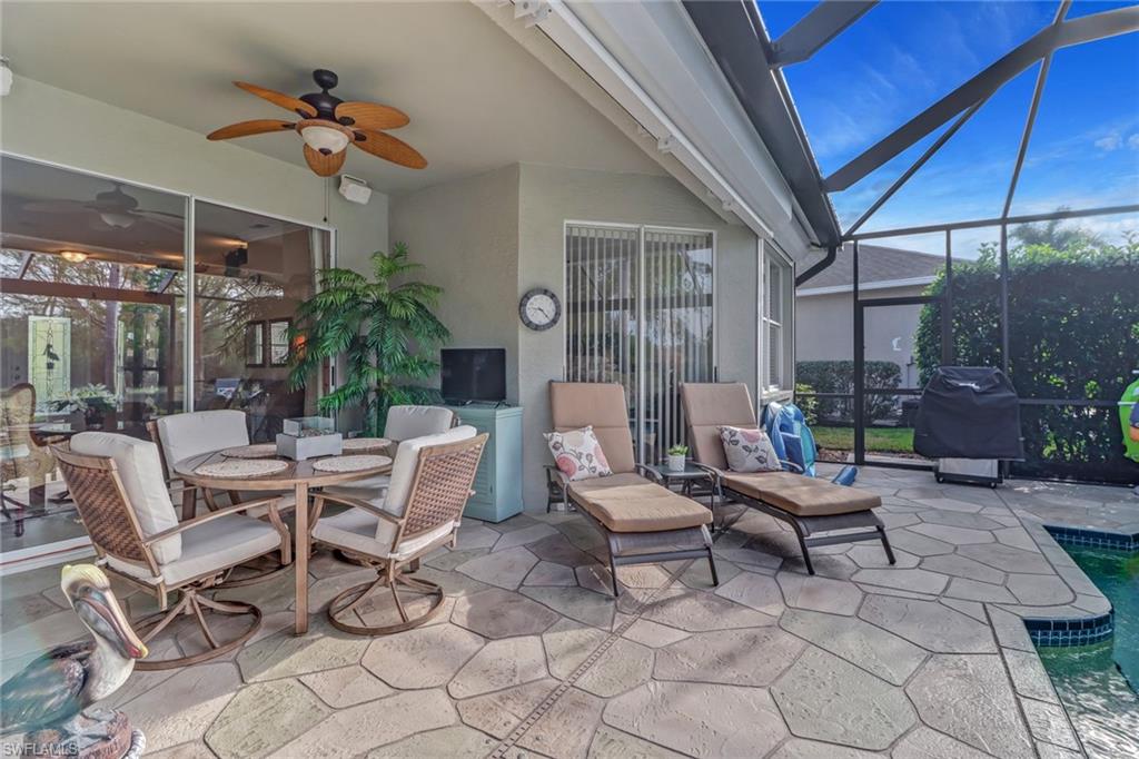 21156 Braxfield Loop Estero, FL 33928 - Photo 23 of 43 a view of a patio with a table and chairs under an umbrella