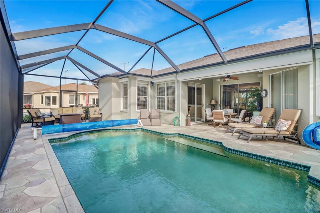 21156 Braxfield Loop Estero, FL 33928 - Photo 27 of 43 a view of a patio with swimming pool table and chairs