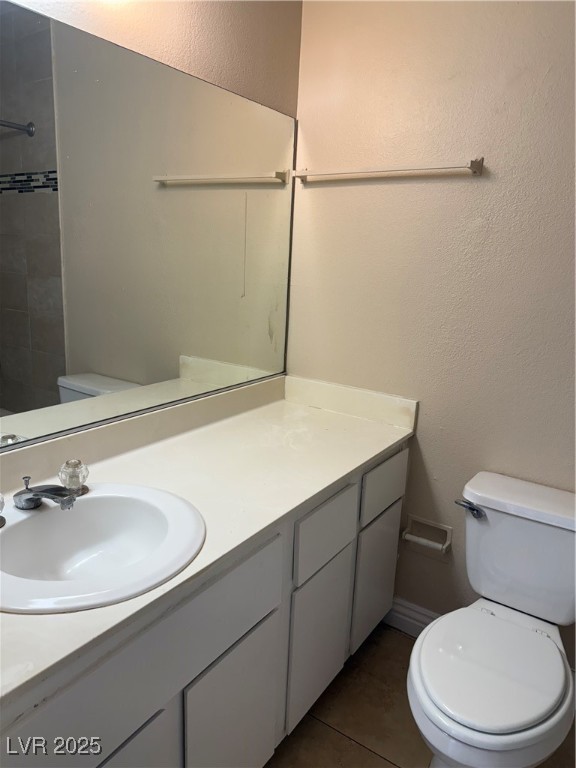 4689 West Sand Creek Avenue, Unit C Las Vegas, NV 89103 - Photo 11 of 14 Bathroom with a textured wall, light tile patterned floors, vanity, and a shower