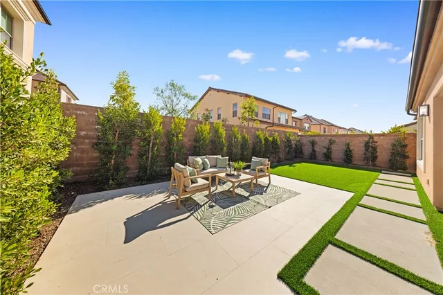 a view of a backyard with sitting area
