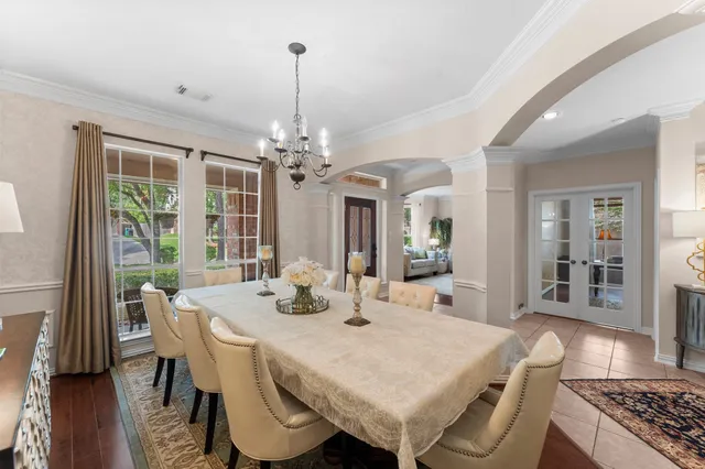 a view of a dining room with furniture wooden floor and chandelier