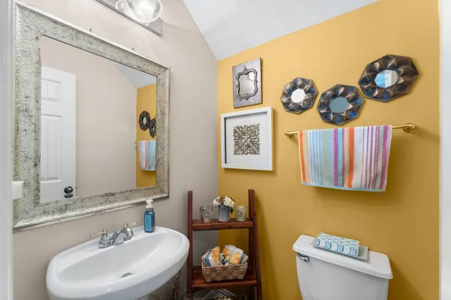 a bathroom with a sink mirror and toilet
